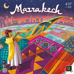 Cover from Marrakech: a young carpet salesman lays out a carpet on top of a bright patchwork of others