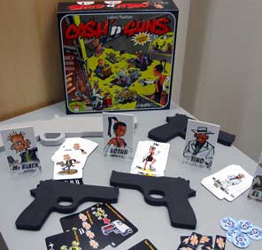 The toy guns and other components of Cash 'n Guns in front of the box