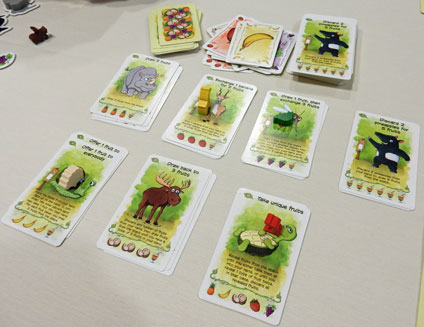 Playing Fabled Fruit: an array of cards with players' pawns on those they've used