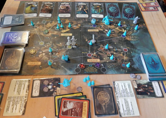 Pandemic: Reign of Cthulhu in play - lots of cards and playing pieces on and around the board