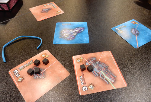 Stellar Conflict: spaceship cards and a rubber strip...
