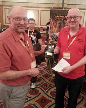 Pevans receives his plaque for winning the Suburbia tournament at the 2014 UK Games Expo