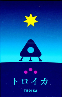 The Troika box: a three-legged spaceship against a blue background under a yellow star