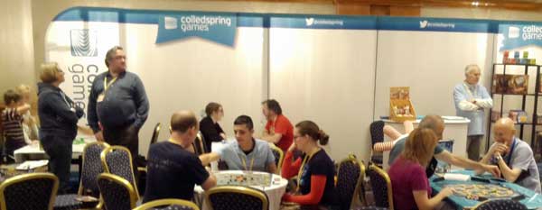 Playing games on the Coiled Spring stand at the UK Games Expo 2014