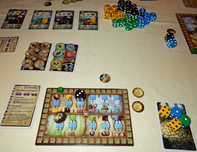 Playing Dice Brewing: note my storage area on the right and a black die and a seed producing things. Available brew cards are at the top and there are plenty of dice!