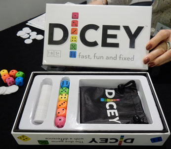 Photo of Dicey in its presentation box: brightly coloured dice, chips and drawstring bag