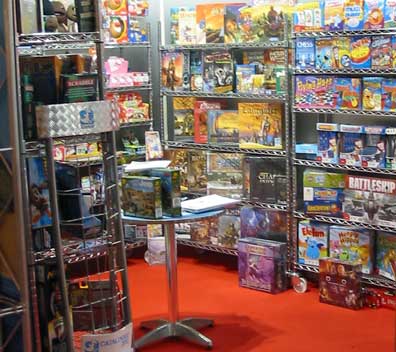 The rear bview of Esdevium's stand with shelves of brightly coloured game boxes