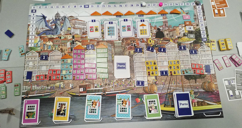 Playing Porto at Spiel '19: the colourful board with three buildings completed so far