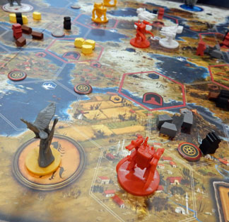 Photo of Scythe pieces on the board
