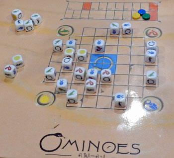 An Ominoes game in progress on the wooden board